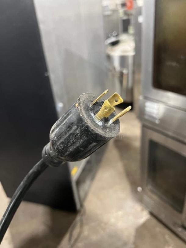 Maxx Cold MXM2-48F power plug close-up, showing sturdy prongs for commercial freezer. Features durable construction.