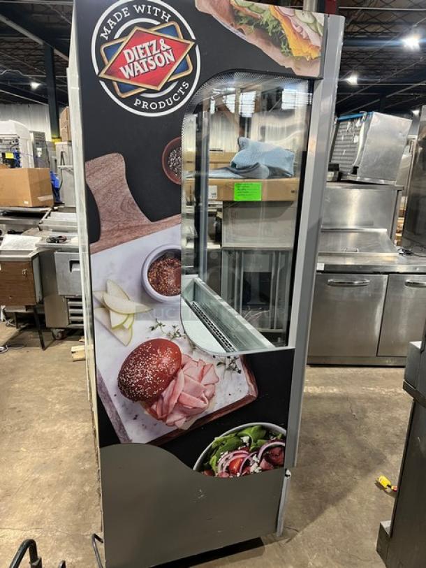 Ojeda ALPA120G2 refrigerated merchandiser with Dietz & Watson graphics, pull-down night curtain, on legs, 120V, 1 phase.