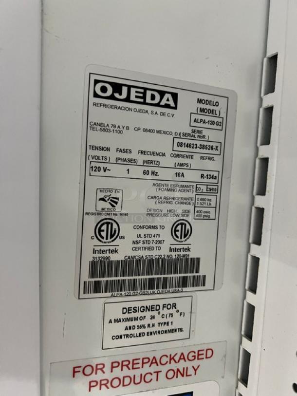 Ojeda refrigerated display case label, Model ALPA-120 G2, SN: 0814623-38526-X, 120V, with certification and usage details.