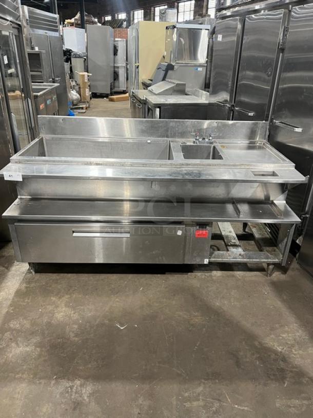 Custom stainless steel bar station with drawer, ice bin, sink, drain board, backsplash, on legs; excellent condition.