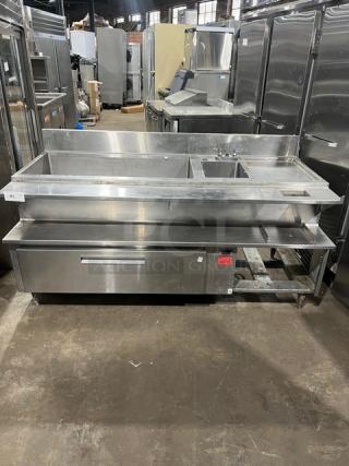 Custom stainless steel bar station with drawer, ice bin, sink, drain board, backsplash, on legs; excellent condition.