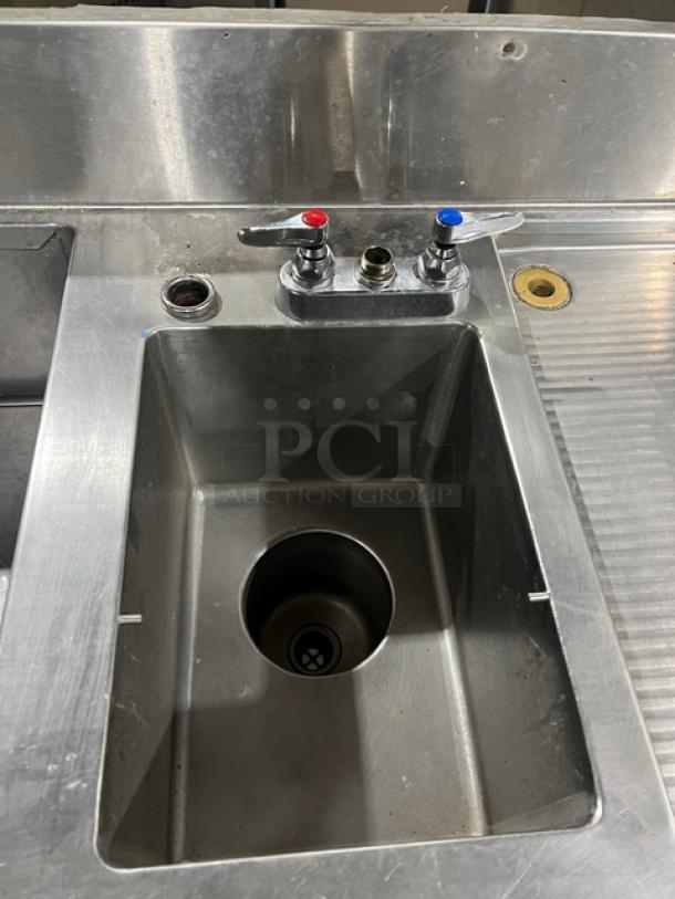 Custom commercial stainless steel cocktail station with single drawer, backsplash, integrated ice bin, sink, and drain board.