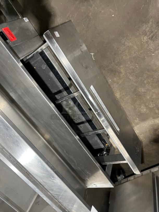 Custom commercial stainless steel triple bar station, featuring a single drawer, backsplash, integrated ice bin, single sink with rigged drain board, on legs.