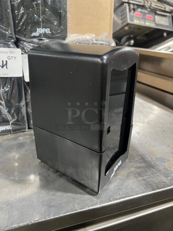 NEW Jofel black countertop tall-fold napkin dispenser, excellent condition, logo visible, ideal for commercial use.