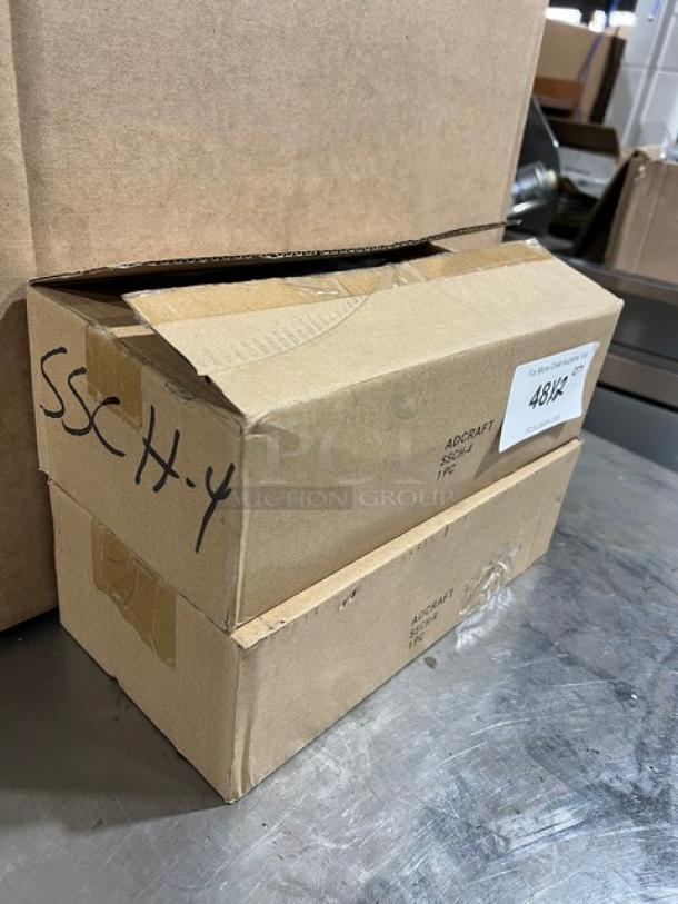 Adcraft SSCH4 condiment dispenser in box, stainless steel, clear acrylic lid, frost white inserts, new condition.