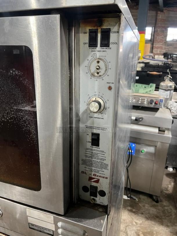 Southbend SL Series commercial stainless steel gas convection oven, double stacked, with wired rack and casters, good condition.