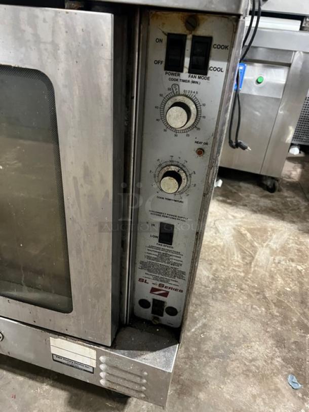 Southbend SL Series stainless steel double stack convection oven, gas powered with wired rack, on casters, used condition.