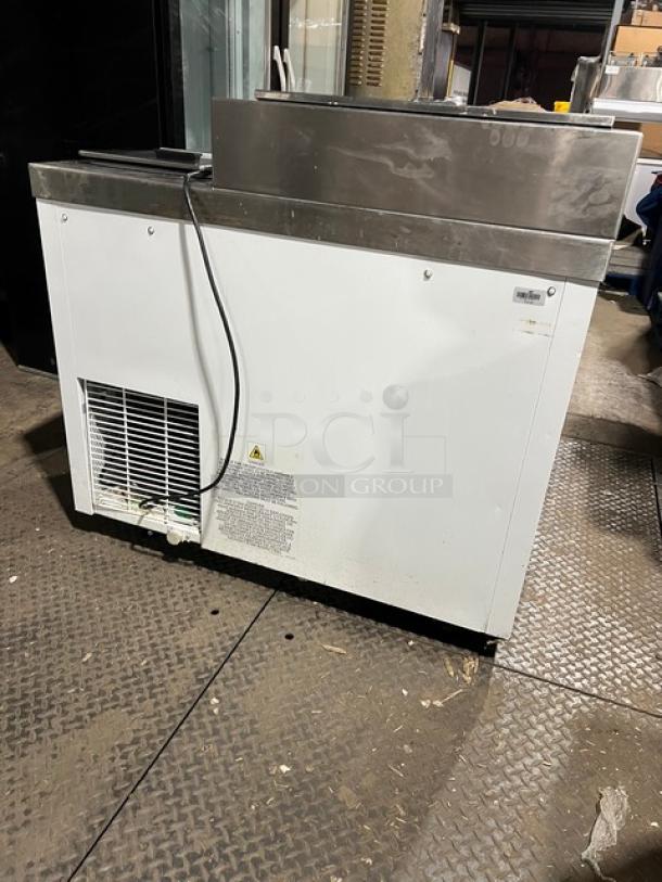 Master-Bilt ice cream topping unit with refrigerated base, model FLR60. White, 115V, on casters, visible wear.