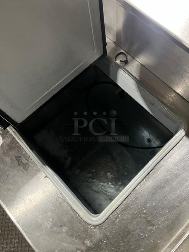 Master-Bilt FLR60 commercial ice cream topping unit with open refrigerated base, stainless steel finish, on casters.