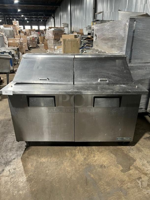 True TSSU-60-24M-B-ST-HC 2 Door Refrigerated Prep Table, stainless steel, wired racks, on casters, commercial use.