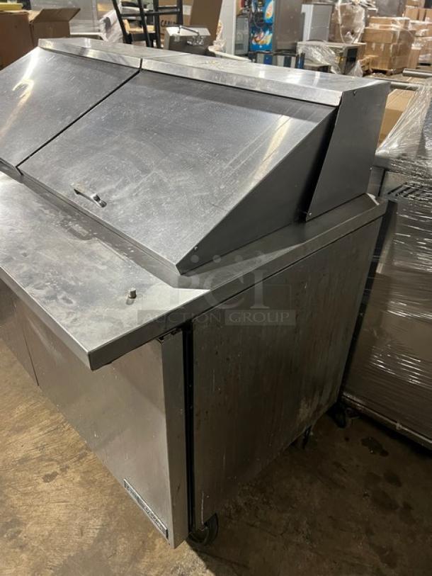 True TSSU-60-24M-B-ST-HC 2-door refrigerated bain marie prep table, stainless steel, wired racks, on casters, commercial use.