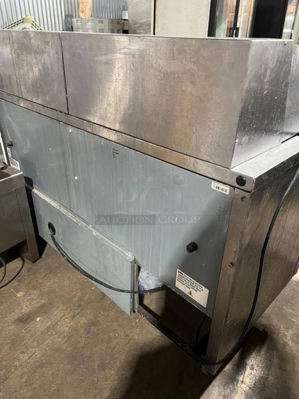 True commercial stainless steel 2-door refrigerated prep table, model TSSU-60-24M-B-ST-HC, on casters, with wired racks.