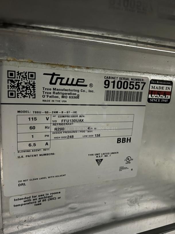 True TSSU-60-24M-B-ST-HC prep table label, SN 9100557, 115V 1 phase, features stainless steel, Made in USA, on casters.