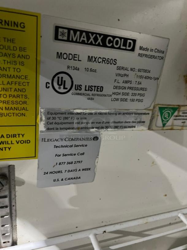Maxx Cold MXCR60S stainless steel refrigerated prep table, model MXCR60S, SN 6070834, with poly-coated wired rack, 115V, on casters. Labels display model info and service contact.