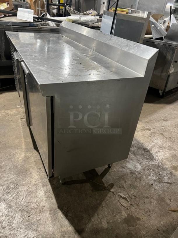 Commercial stainless steel 2-door refrigerated pizza prep table, Model 51268AM, SN W00000028197, 115V, on legs.