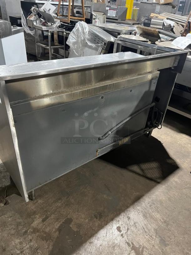 Stainless steel 2-door refrigerated pizza prep table, Model 51268AM. 115V, 1 phase, on legs, good condition.