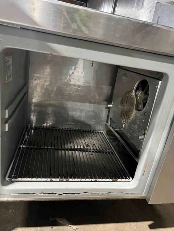 Commercial stainless steel 2-door refrigerated pizza prep table, model 51268AM SN: W00000028197, 115V 1-phase, on legs, interior view.