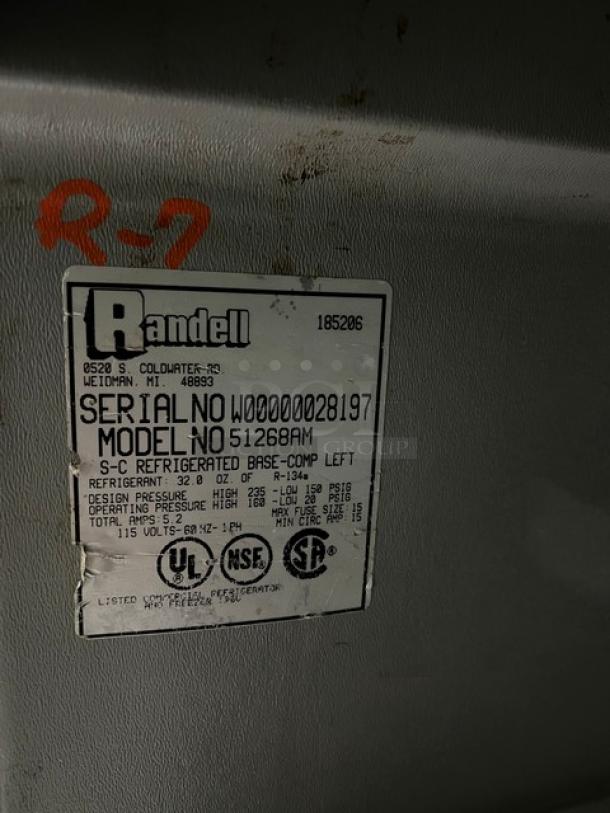 Randell label on stainless steel refrigerated pizza prep table, Model 51268AM, Serial No. W00000028197, 115V, on legs.