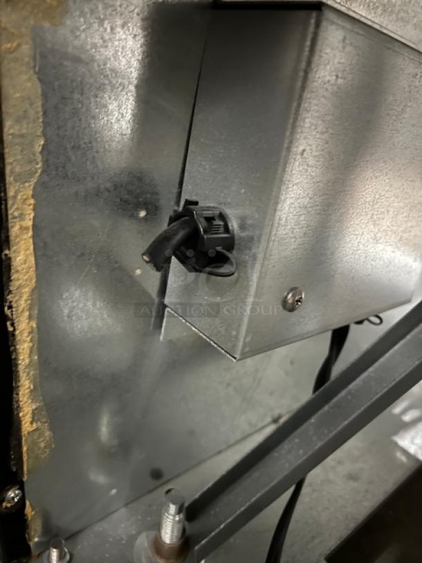 Internal view of a Beverage-Air MarketMax Series MMR491BLEDEL glass merchandiser, showing metal and bolt detail.