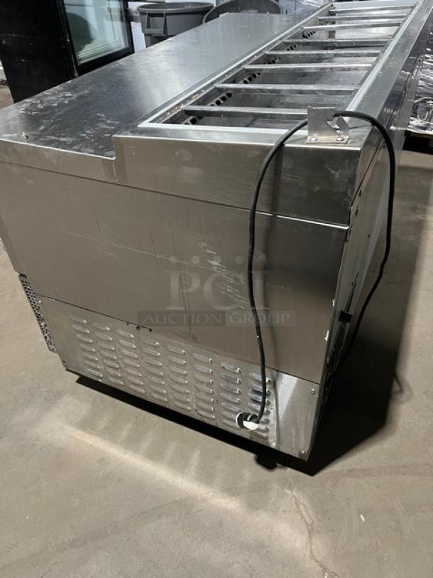 Continental CPA60 stainless steel refrigerated pizza prep table with wired rack, 115V 1 Phase, on casters, SN: 155C1556.