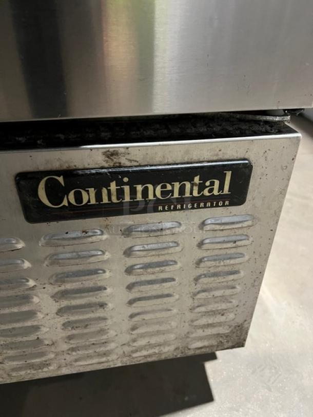 Continental CPA60 stainless steel refrigerated pizza prep table with wired rack, 115V, 1 Phase, on casters, model label visible.