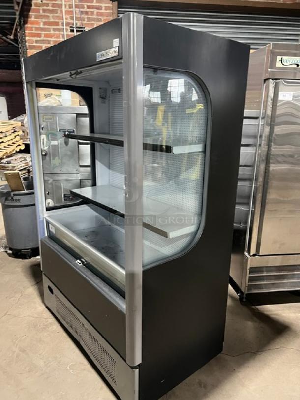 Beverage-Air commercial black refrigerated display case, model VM18, with pull-down night curtain, adjustable shelves, and serial number 0721176-36481-U.