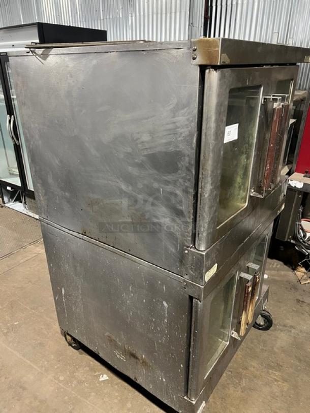 Vulcan commercial stainless steel double-stacked electric convection oven on casters, with wired oven rack; visible wear.
