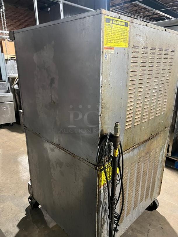 Vulcan stainless steel double-stacked convection oven with wired rack, on casters, electric-powered, industrial condition.