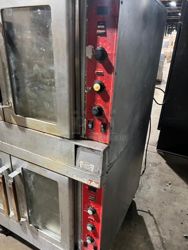 Vulcan double-stacked stainless steel electric convection oven with wired rack, on casters. Visible wear, red control panel.