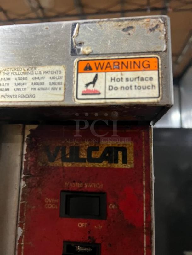 Vulcan commercial stainless steel double-stacked convection oven, electric powered, with warning label about hot surface.