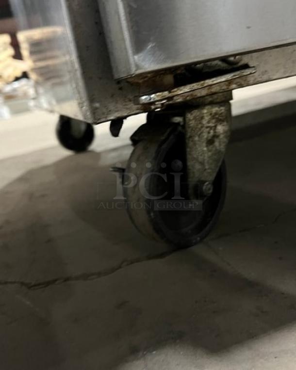 Continental CPA60 refrigerated pizza prep table, stainless steel, on casters, model details visible, includes wired rack.