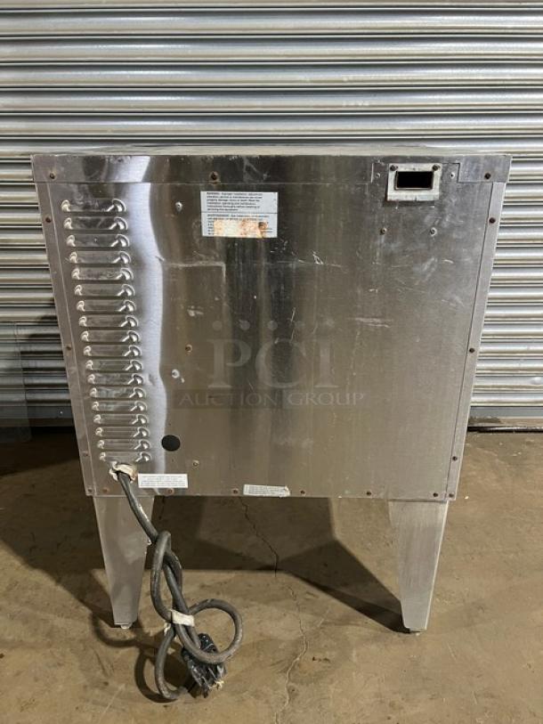 Duke commercial stainless steel single stacked convection oven on legs, wired rack included, electric powered, rear view.