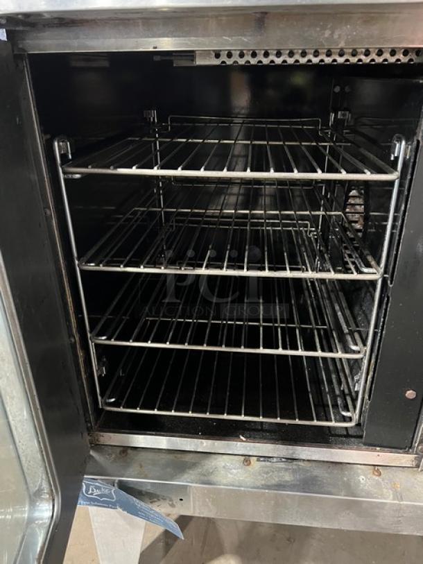 Duke commercial stainless steel electric convection oven, single stacked with wired oven rack and on legs, used condition.