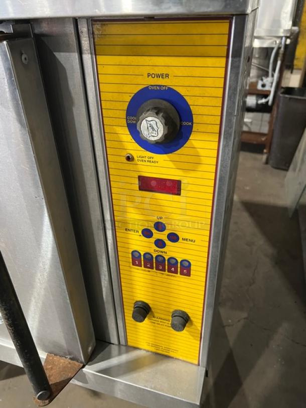 Duke commercial stainless steel single stacked electric convection oven with wired oven rack and control panel, on legs.