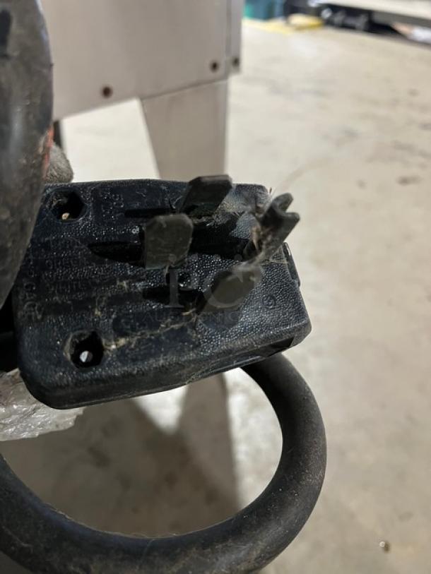 Plug of a Duke Commercial Stainless Steel Electric Convection Oven, close-up, showing wear and dirt.