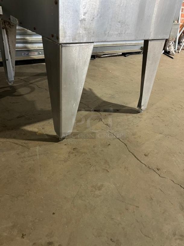 Duke commercial stainless steel convection oven on sturdy legs, featuring wired oven rack. Visible wear, functional condition.