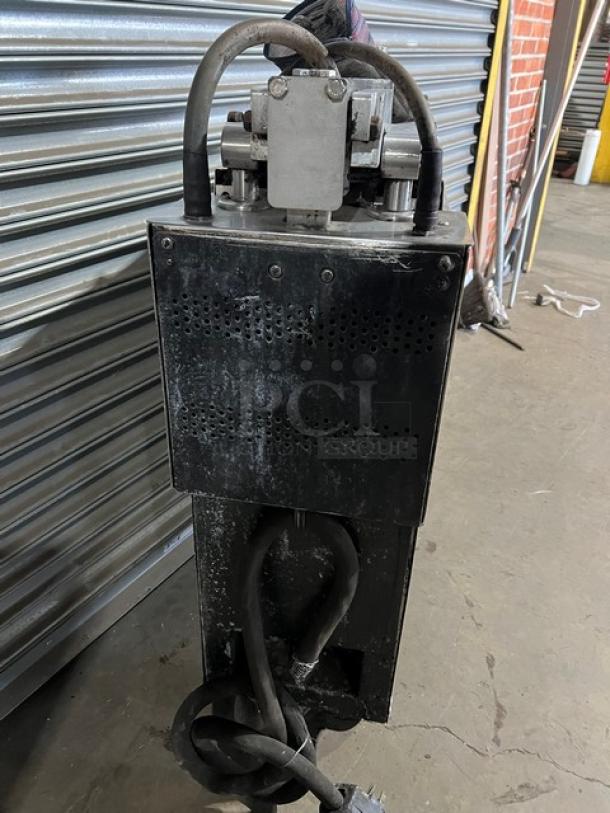 Alt text: Garland CXBE12 stainless steel electric hamburger press with wavy grates, on casters, showing rear view and power cables, 208V 3 Phase.