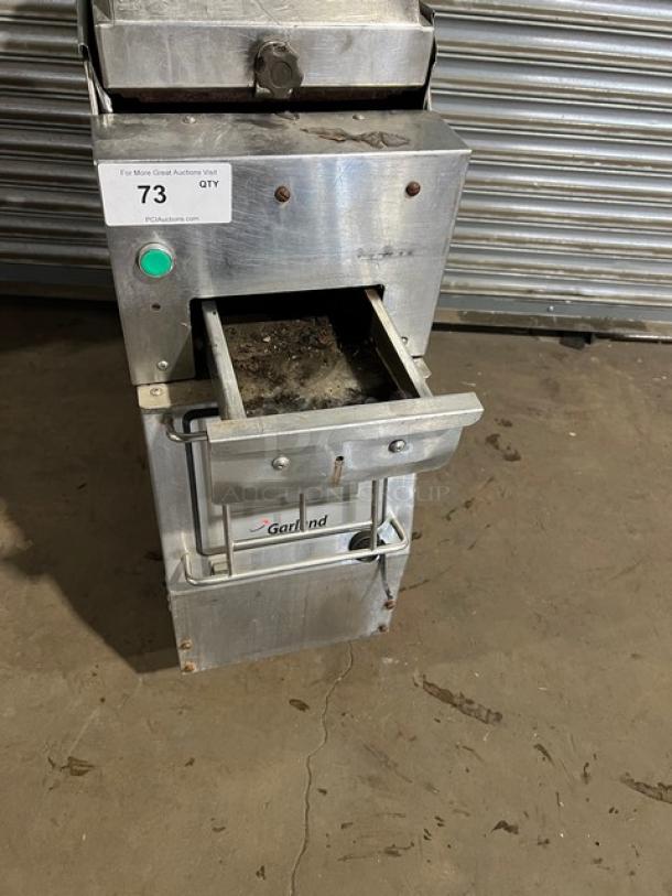 Garland CXBE12 stainless steel electric hamburger press with wavy grates, on casters, showing operating panel and drawer.