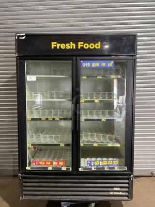 True GDM-49 commercial refrigerator with black frame, double glass swing doors, poly-coated racks, and beverage organizers.