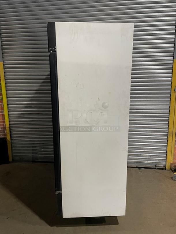 True Commercial double glass door refrigerator, model GDM-49, with poly coated racks and beverage organizers, side view.