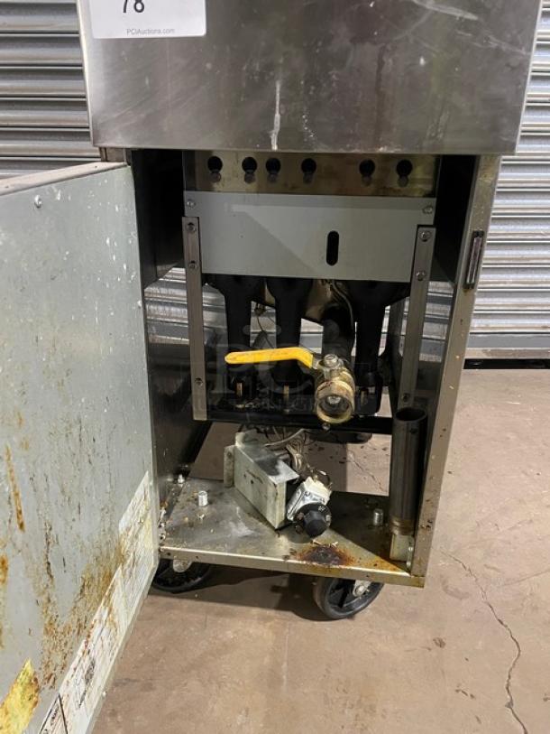 Asber AEF-4050-S-E-NG commercial stainless steel deep fat fryer with back splash, on casters. Natural gas-powered. Visible wear.