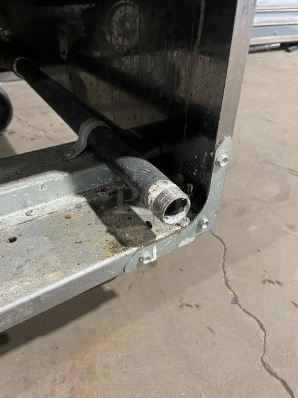 Asber AEF4050SENG deep fat fryer, natural gas, stainless steel, visible interior tubing, on casters, shows wear.