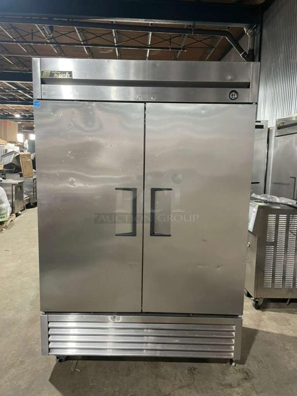 True T-49F commercial 2-door stainless steel reach-in freezer, Energy Star certified, with poly-coated wire rack, on casters.