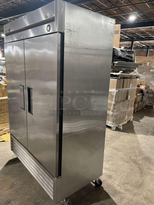 True T-49F stainless steel 2-door reach-in freezer, Energy Star certified, on casters, with poly coated wire rack.