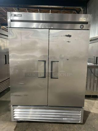 True T-49F stainless steel 2-door reach-in freezer, Energy Star certified, on casters, with poly coated wired rack.