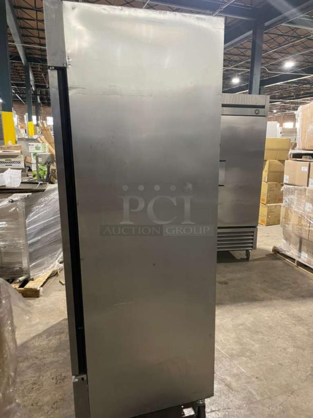 True T-49F commercial stainless steel reach-in freezer, two solid doors, Energy Star certified, on casters, poly-coated rack.