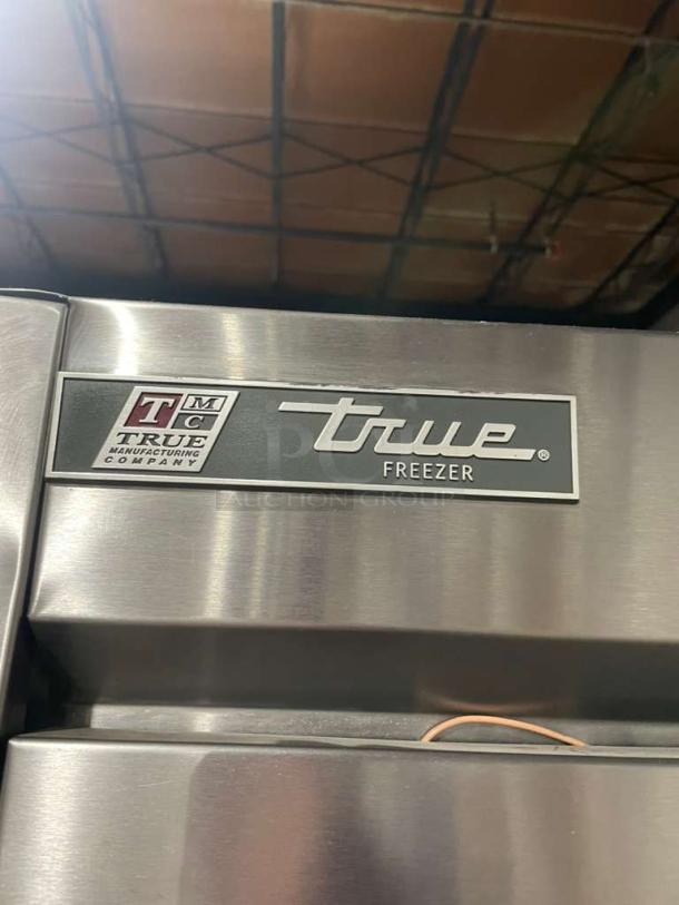 True T-49F commercial stainless steel 2-door freezer, Energy Star certified, with poly coated racks and casters.