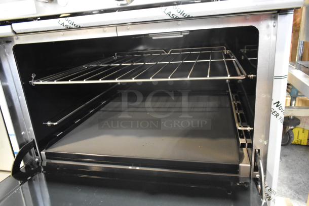 Southbend 4601DD stainless steel 10 burner range, new condition, featuring dual ovens and backsplash, interior rack visible.