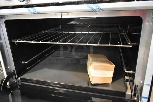 Interior of Southbend 4601DD oven showing a single rack and a small cardboard box. Stainless steel, new condition.