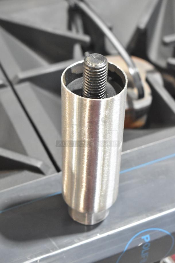 Close-up of a component from a Southbend 4601DD burner, showing a metal threaded piece used in the commercial gas range.